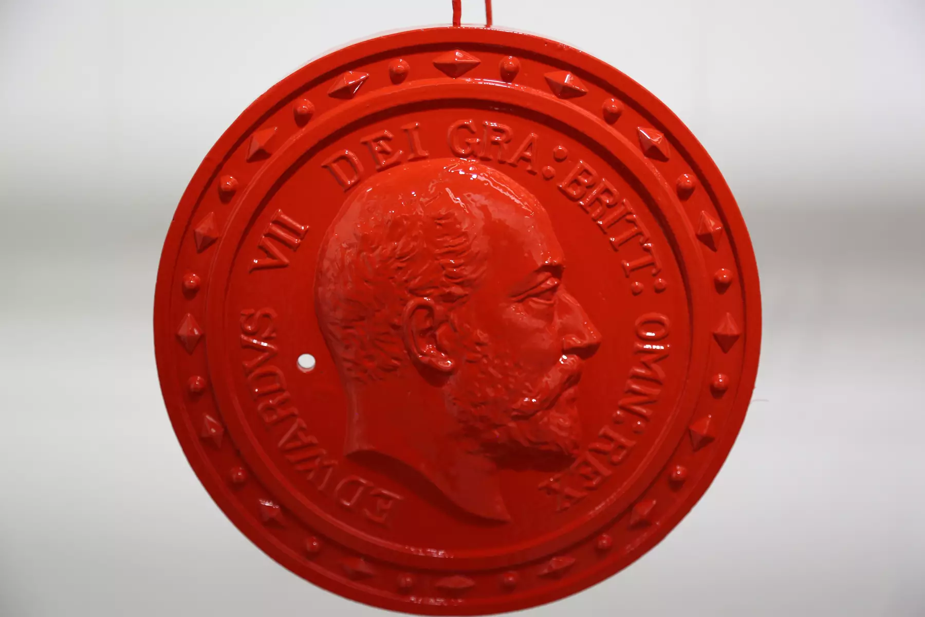 One of two red plaques primed and painted